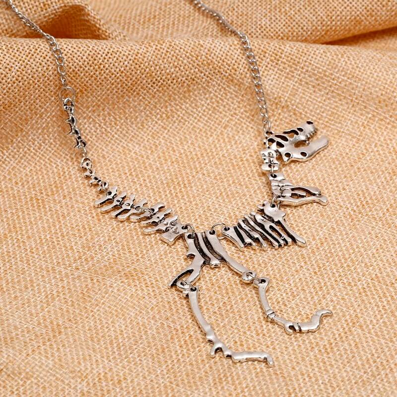 Kvinner T-Rex skjelettkjede i bronse eller gull, perfekt for dinosaur-entusiaster.