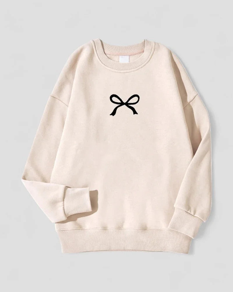 Koselig oversized damegenser med sløyfe. Bomullsblanding gir varme og komfort for enhver anledning.