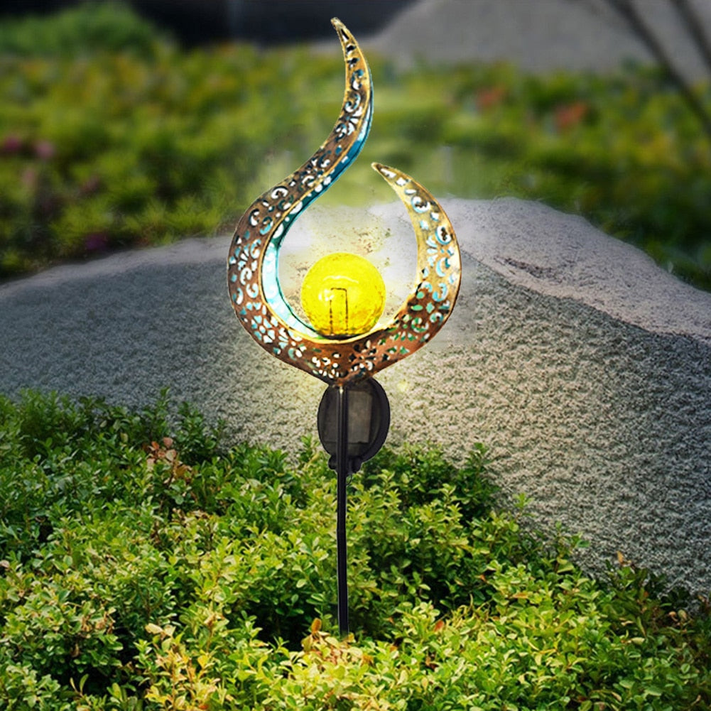 Retro solcellelampe lyser vakkert i skumringen. Mykt utelys som skaper magisk stemning ute.