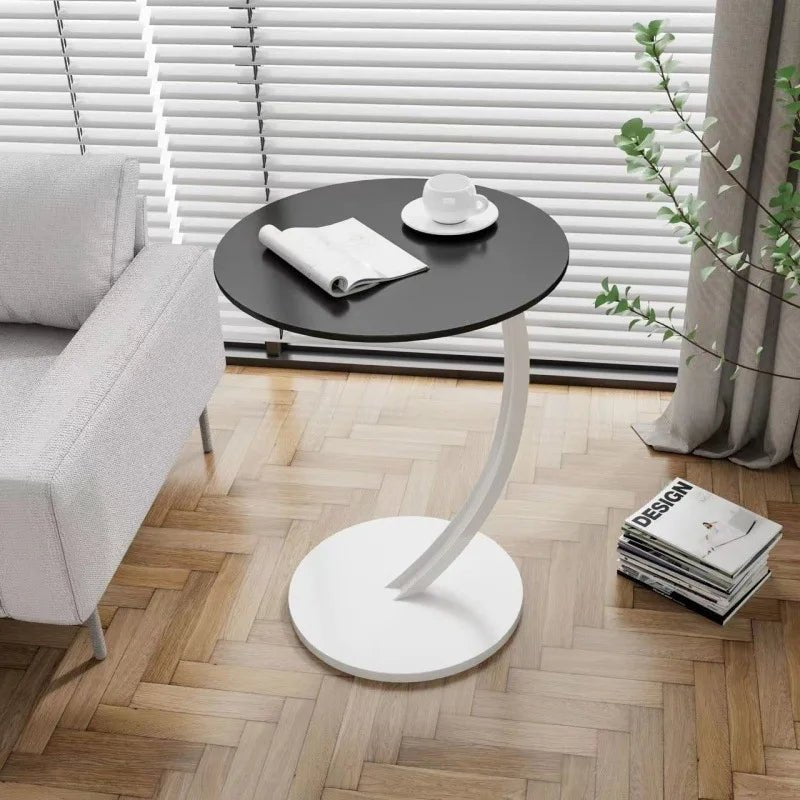 Rundt salongbord ved en sofa, et kompakt og moderne tillegg til stuen for drikke og dekor.