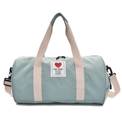 Kvinne bærer stilfull sort nylon duffelbag, perfekt for reise, trening og weekendturer.