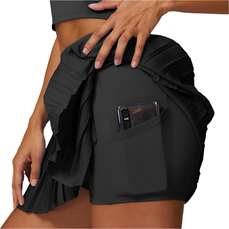 Stilfullt plissert dameskjørt med integrert shorts, perfekt for sporty aktiviteter og komfortabel fritid.
