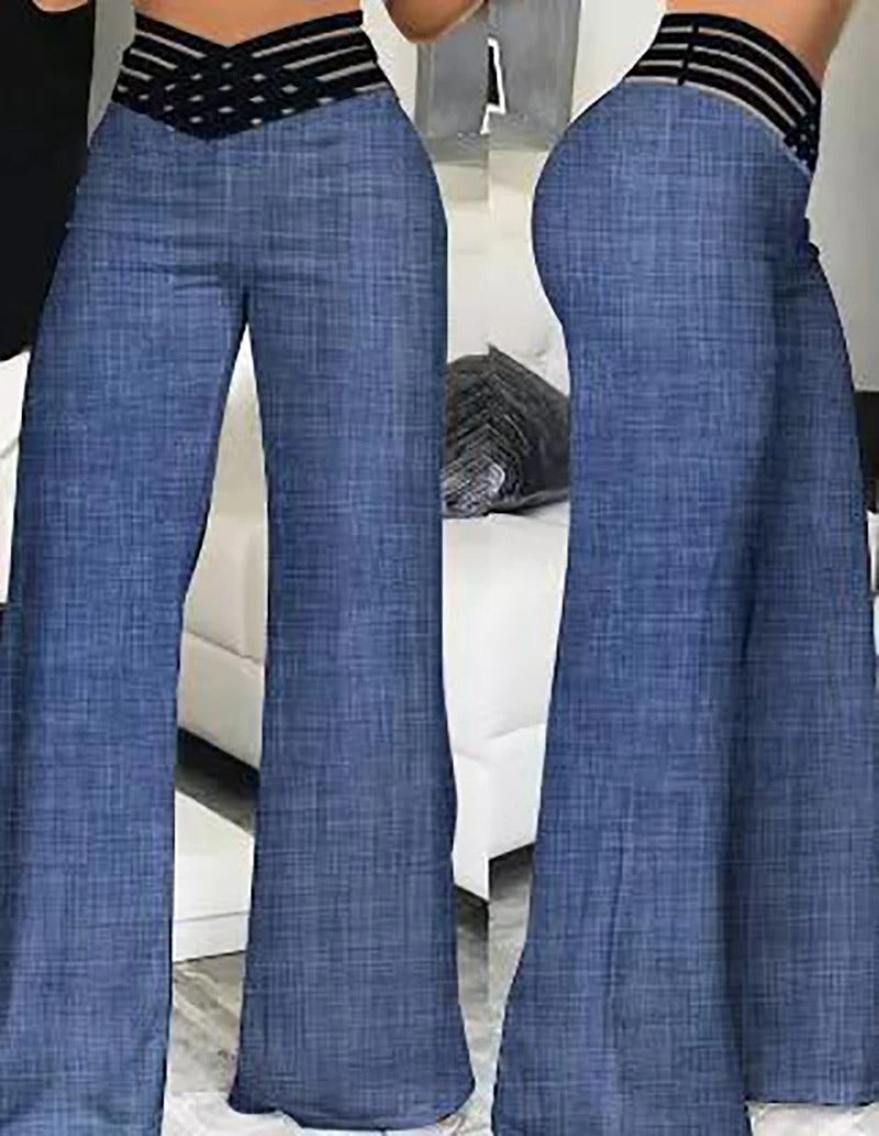 Svart festbukse med transparent mesh og høy midje, som gir en slående og moderne silhuett.