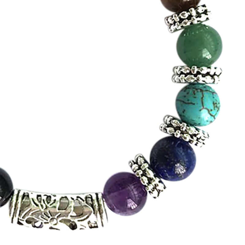 Stilig unisex chakra armbånd med ekte krystaller, kombinert med andre smykker for en unik look.
