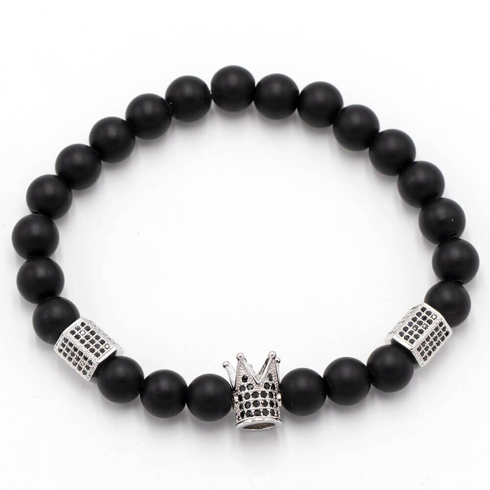 Unisex onyks steinarmbånd med krone og hodeskalle på håndledd. Et iøynefallende tilbehør av naturstein.