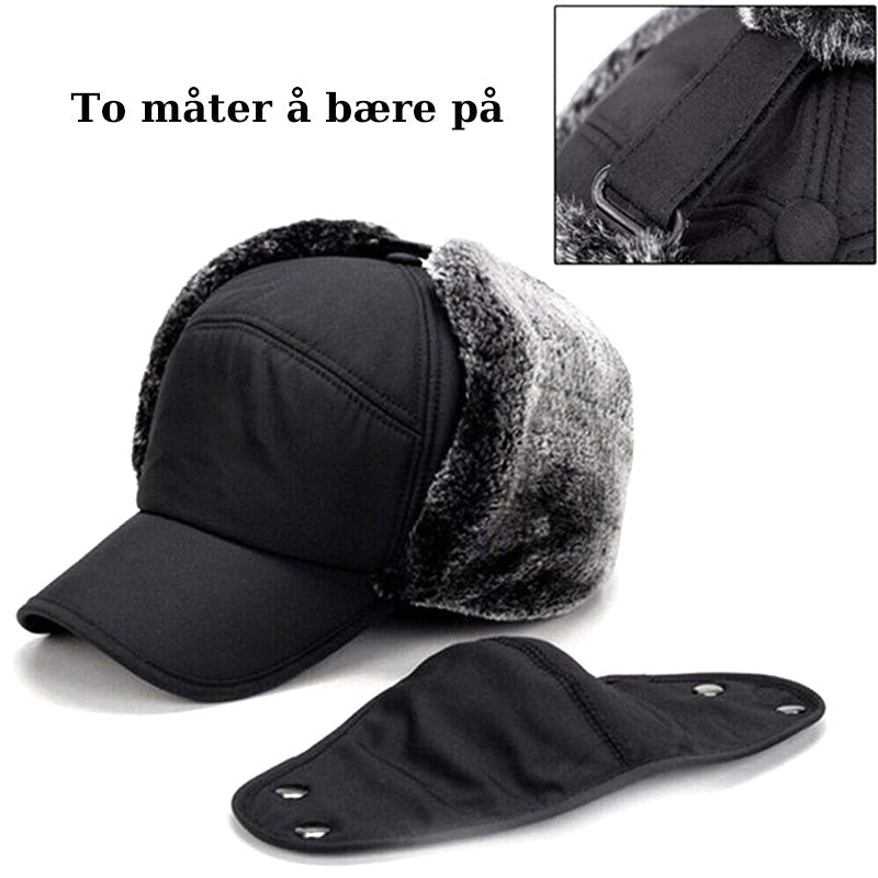 Person i snølandskap iført varm unisex vinterlue med vindtett ansiktsbeskyttelse.